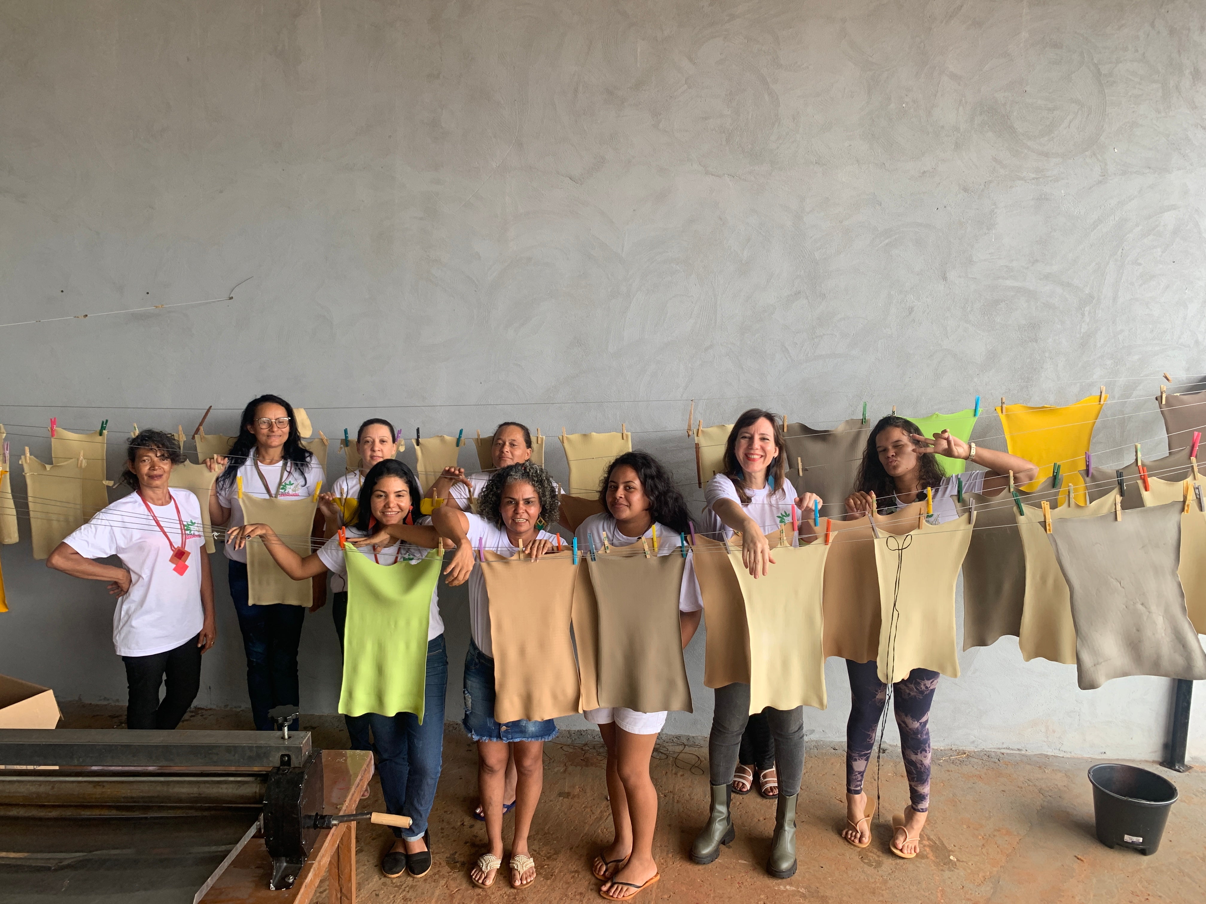 Mulheres do coletivo com as mantas de FSA penduradas no varal